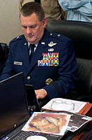 Marshall B. Webb, an American general, sits in the White House Situation Room during Operation Neptune Spear. A classified document on the desk in front of him was pixelized by the government of the United States before the photo was released.
