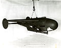 The "Pelican" was developed concurrently with the "Bat" by NBS, the Navy Bureau of Ordnance, and the MIT Radiation Laboratory. The "Pelican" is shown with instrumentation for field testing. Directly beneath the wing, shown in the photo, was mounted a 16mm Bell and Howell Type M-4A gun sight aiming point camera. Slightly forward and lower was mounted a 16mm Cine Kodak Model E camera. The housing on the nose covered a panel of signal lamps indicating the application of radar controls. The cameras simultaneously photographed the panel and the ground ahead of the glider.