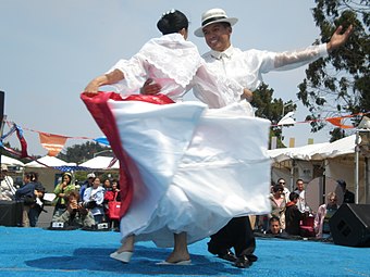 Dancers in barong tagalog (with a buntal hat) and traje de mestiza performing Jota Cagayana