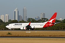 A Boeing 737-800 at Perth Airport with the city of Perth in the background (2004). Qantas Boeing 737-800 PER Monty-1.jpg