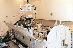 The payload being prepared for launch in a transfer container. Visible is the WSF-3 (being lowered in), and ORFEUS-SPAS II (Already in place) STS-80 Payload 01.jpg