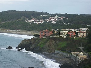 China Beach is seen in the foreground with the sea wall. Baker Beach can be seen in the distance