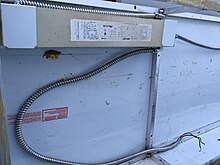 An American magnetic ballast for signs in an aluminum sign frame. Sign ballasts are heavier duty than other ballasts because the cooler outdoor temperatures increase the energy required to start a fluorescent tube. They are sized based on the total tube length used. Sign ballast.jpg
