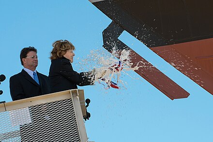 Kate Lehrer, sponsor of the future USS Wichita (LCS 13), breaks a bottle of champagne across LCS-13's bow during the ship's christening ceremony.