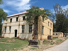 One of the buildings at the old St Matthews Mission School St Matthews Old building with treegrowing.jpg
