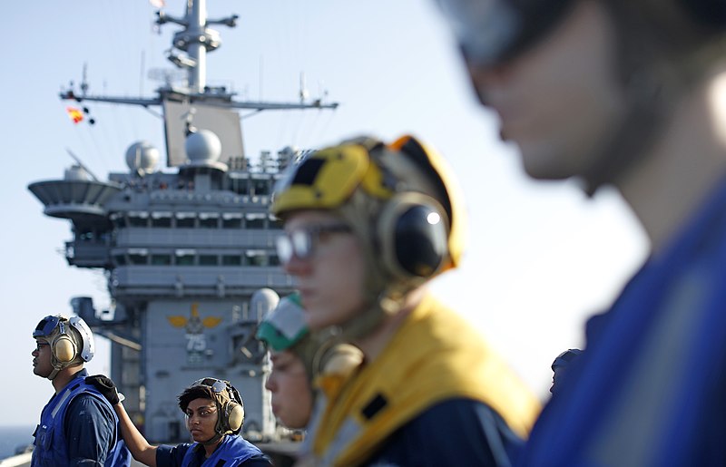 File:U.S. Navy Seamen Anthony Lebron, background left, and Jasmine Harris, second from left, stand with other Sailors while preparing for a replenishment at sea aboard the aircraft carrier USS Harry S. Truman (CVN 130723-N-RA063-001.jpg