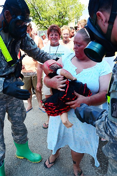 File:U.S. Soldiers with the 44th Chemical Company, 2nd Chemical Battalion at Fort Hood, Texas, assist role players in a simulated decontamination line July 29, 2012, at the Muscatatuck Urban Training Center 120729-A-IA524-509.jpg