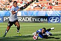 Image 5 Goalkeeper (football) Photo credit: Nick Wiebe Congo national football team goalkeeper Destin Onka (right) prevents Austrian forward Rubin Okotie (left) from scoring a goal at the 2007 FIFA U-20 World Cup. In association football, the goalkeeper is the only player who is permitted to touch the ball with his hands or arms in open play. More selected pictures