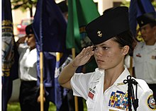 Radford High School JROTC student salutes during colors ceremony. The public school is located one mile from Joint Base Pearl Harbor-Hickam. 62% of its students are military dependents, also called "military brats", resulting in a yearly transiency rate of about one third. US Navy 040601-N-4995T-077 Battalion Commander Cadet Ensign Melanie Leonard, of Radford High School Junior ROTC, salutes during the parading of the colors ceremony held at the Parchee Memorial Submarine Base at this year's Memo.jpg