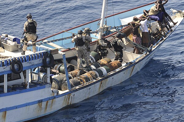 A combined U.S. Navy/U.S. Coast Guard VBSS team from USS Chosin (CG-65) and embarked MSST personnel inspects a suspected pirate dhow in the Gulf of Ad