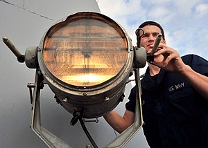 US Navy 120125-N-NL401-269 A Sailor aboard the Arleigh Burke-class guided-missile destroyer USS James E. Williams (DDG 95) uses a fog light as a wa.jpg