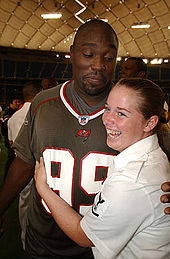 Warren Sapp (left), whose number 99 was retired by the Buccaneers, visits members of the US Navy in 2003 Warren Sapp.jpg