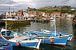 Whitby harbour overlooked by the Abbey ruins on the skyline.