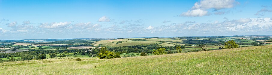 Panorama at Win Green showing patchwork of rolling hills with pastures and scattered woodlands along the northern chalk escarpment of Cranborne Chase above the Vale of Wardour.