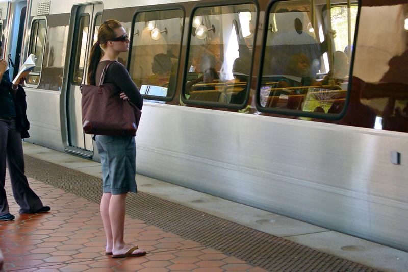 File:Woman waiting at Fort Totten (50259496432).png