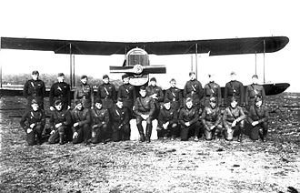 Pilots of the 100th Aero Squadron along with a Dayton-Wright DH-4, Ourches Airdrome, France, November 1918 100th Aero Squadron - pilots and DH-4.jpg