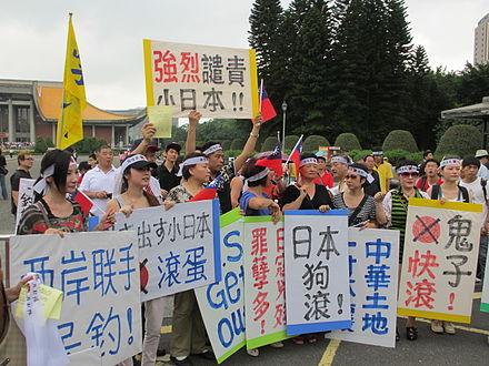 Demonstrators in Taiwan host signs telling "Japanese devils" to "get out" of the Senkaku Islands after an escalation of disputes in 2012.