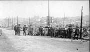 Thumbnail for File:Aftermath of the Seattle fire of June 6, 1889 looking north on Commercial St showing a small crowd and a guard with safes (SEATTLE 2429).jpg