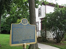 A historical plaque to the side of the Henderson Home, commemorating Canada's first telephone business office of 1877. Alexander Graham Bell in Brantford, Ontario, Canada -plaque commemorating Canada's first telephone company office, established in Brantford, Ontario, 1877 -panoramic view.jpg