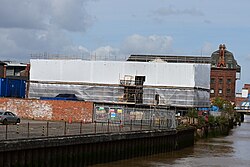 Progress on the Arctic Corsair Visitor Centre on the west bank of the River Hull. Timber frames have now been installed for the roof, albeit left under cover with tarpaulin.