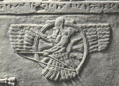 Feather robed and turbaned archer figure of Ashur (a later development of Enlil) superimposed on a sun disc