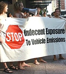 Protesters gathered outside a courthouse on 17 Feb 2005 to protest against the arrest of Simon Oosterman (second from left), Auckland's 2005 WNBR organiser. Banner protesting vehicle emissions at the World Naked Bike Ride, Auckland, New Zealand - 20050217.jpg