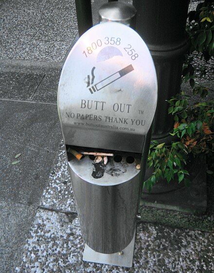 A cigarette disposal canister, encouraging the public to dispose of their cigarettes properly