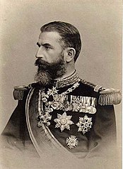 King Carol I of Romania, wearing the collar of the Royal House Order of Hohenzollern around his neck and the pinback Honor Cross 1st Class with Swords of the Princely House Order of Hohenzollern on his lower left breast. He also has a Knight's Cross with Swords of the Royal House Order of Hohenzollern on his medal bar. Carol I King of Romania.jpg