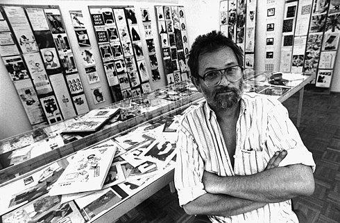 Gyorgy Galantai with the exhibition organized from the material of Budapest Session of the 1992 Decentralized World Wide Networker Congress and Artpool's first fax action in the background Galantai Gyorgy az Artpoolban, 1992.jpg