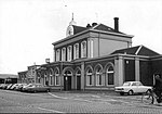 HUA-150840-Gezicht op het NS station Winschoten te Winschoten met parkeerplaatsen en bushalte van de GADO.jpg