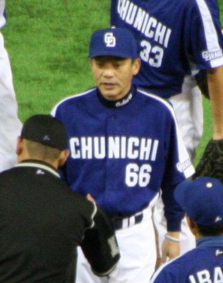 Japanese man wearing a blue and white uniform greets an umpire