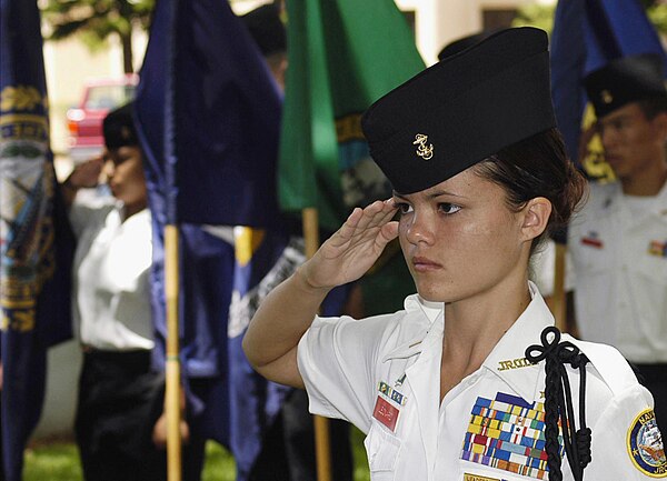 A Navy JROTC cadet salutes during the parading of the colors ceremony held at Pearl Harbor, Hawaii