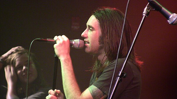 Lead singer Kevin Young in concert performing with Disciple in 2009