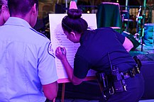 An LAPD officer signs up cadets wanting to compete in a dance contest during the annual Los Angeles Greek Fest in 2013. LAPD Signing up the Cadets.jpg
