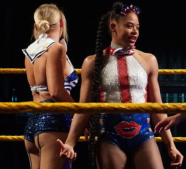 Evans (left) and Bianca Belair before a tag team match at a house show in June 2018