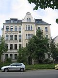 Apartment building in semi-open development with a front garden