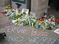 Flowers and inscriptions at the metro entrance