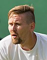 Mateusz Kowalczyk competing in the first round of the 2015 Wimbledon Mens Doubles Qualifying Tournament with Igor Zelenay at the Bank of England Sports Grounds in Roehampton, England. The winners of three rounds of competition qualify for the main draw of Wimbledon the following week.