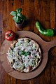 Multiple plates of pizza served on wooden plates on display (49430322308).jpg