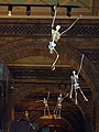 Hanging skeletons live up the ceiling of one of the side corridors of the main hall of the Natural History Museum of London.