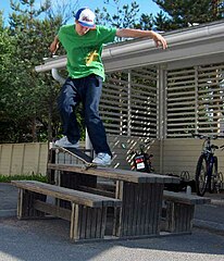 A skateboarder making use of street furniture.