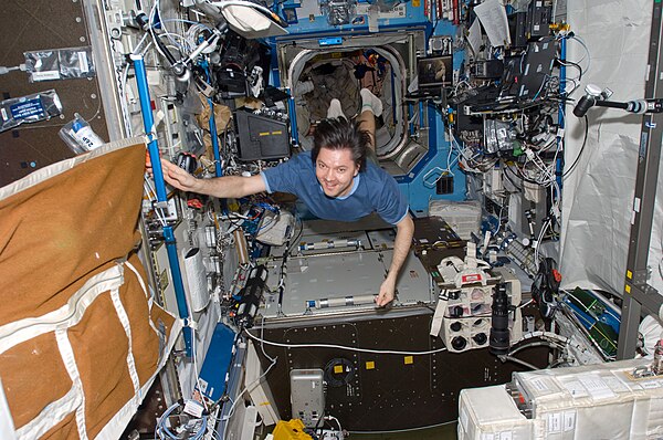 Oleg Kononenko floats through the Destiny Laboratory of the Space Station.