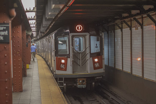 An R188 EMU/trainset departs the 42nd St – Bryant Park station on the 7 service, heading towards 34th St – Hudson Yards.