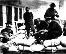 Police setting up a mounted machine gun during the strike. Seattle General Strike 1919 Police setting up mounted machine gun.png