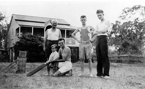 StateLibQld 1 189447 Dahl family playing backyard cricket at Woody Point, February 1935