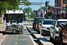 A street sweeper clearing dirt and debris from a bike lane in Minneapolis in 2022. Street sweeper in Minneapolis neighborhood University.jpg