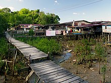 Photograph of house on stilts over water