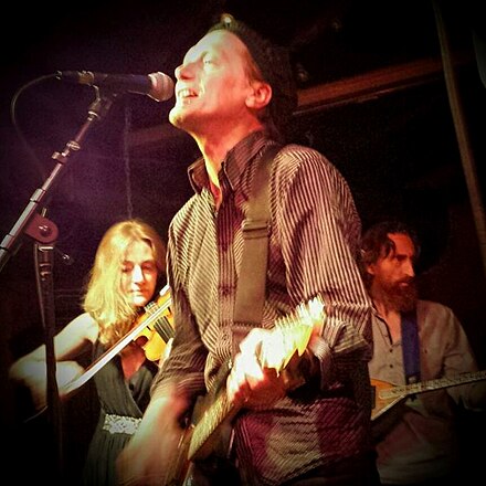 Tom Greenhalgh performing with the Mekons at the Hideout Inn in Chicago on 11 July 2015. Tom Greenhalgh performing with the Mekons at the Hideout on July 11, 2015.jpg