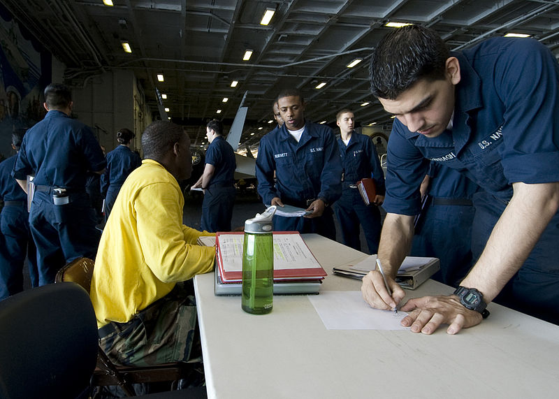 File:US Navy 101205-N-9626Y-007 Aviation Structural Mechanic Airman Jonathon Darragh, right, from Jacksonville, Fla., signs up for a warfare walk-throug.jpg