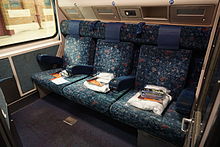 Passenger compartment of an XAM-type carriage in First-Class daysitter configuration. The seatbacks fold forward to provide the lower of two sleeping bunks.